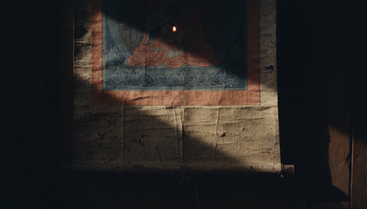 Close-up of a Thangka painting in a dim monastery